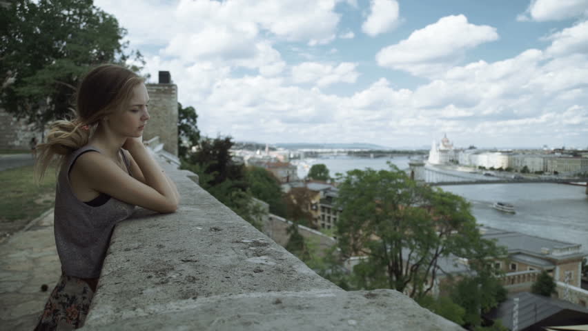 Woman looks at the city from a height