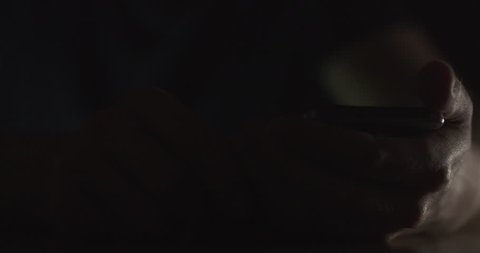 man using smartphone at night closeup