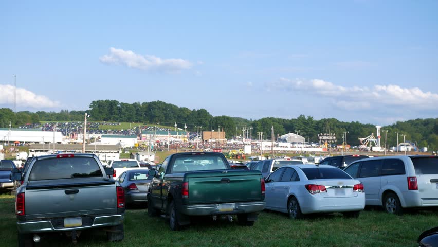 Daytime establishing shot of a county fair in summer