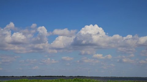 Blue sky with white fluffy clouds, summer day