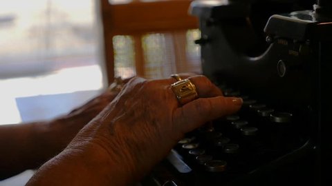 A woman typing on an antique manual typewriter