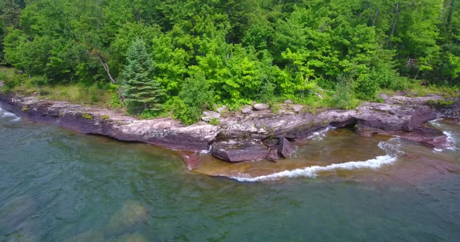 Lake Superior rocky shoreline with waves crashing on a summer day