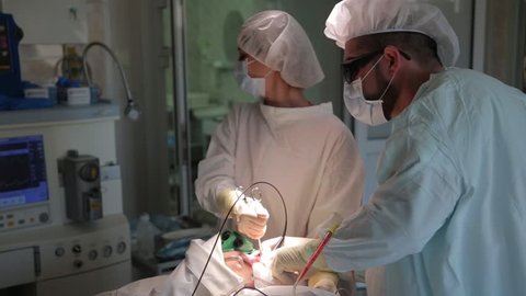 The team of Surgeons removes the cancer tumor. Photodynamic therapy. a cure for cancer