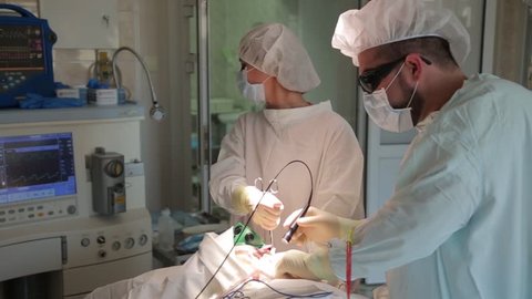 The surgeon performs a surgical procedure. Photodynamic therapy. a cure for cancer