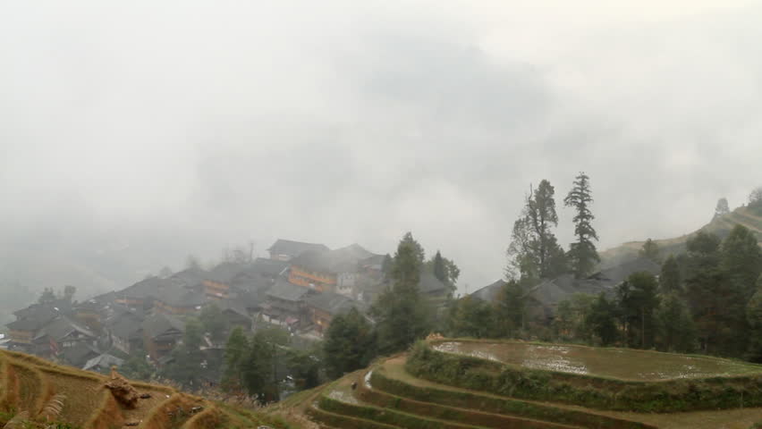 Village and Terraced Rice Field in the Fog - Longsheng, Guangxi province, China.