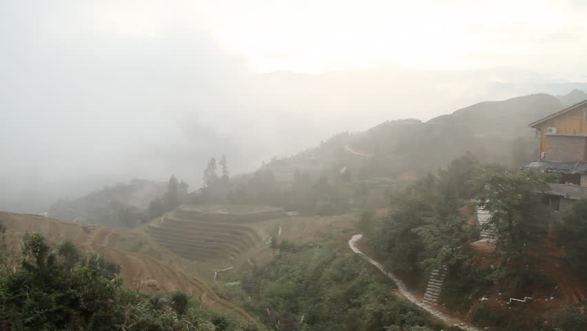 Village and Terraced Rice Field in the Fog - Longsheng, Guangxi province, China.