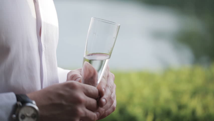 Happy friends talking and drinking champagne