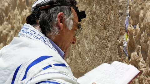 Jerusalem, Israel - May 25, 2017: Jew haredi pray at the Western Wall also known as Wailing Wall or Kotel in Jerusalem. The Western Wall is the most sacred place for all jews and jewish in the world.