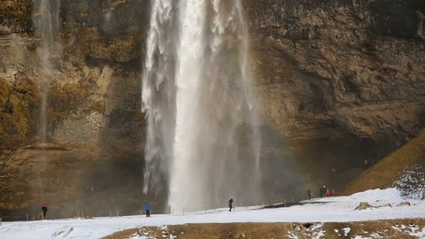 Slowmotion of Seljalandsfoss waterfall close up in Iceland in storming wintertime
