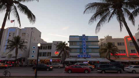 MIAMI BEACH, USA - MAR 14, 2013: 4K Timelapse zoom out of traffic during sunset at Ocean Drive with Palms and iconic hotels