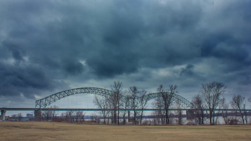 dark clouds coming toward bridge time lapse