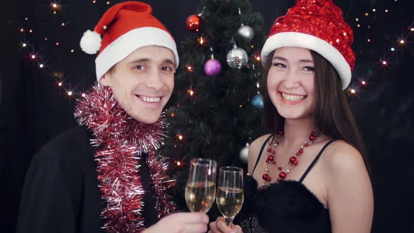 Young couple with wine glasses at christmas party