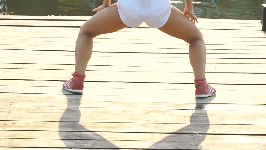 Attractive sensual girl dancing modern passionate dance with buttocks. Slowly