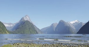 New Zealand touris destination Milford Sound and Mitre Peak in Fiordland National Park, New Zealand. Iconic and famous New Zealand nature landscape of fjord. SLOW MOTION.