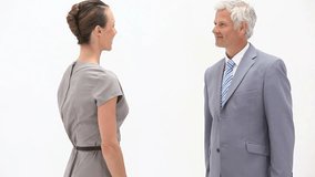 Video of business people shaking hands against a white background