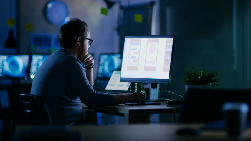 Male Mobile Application Developer Works with Graphics on His Personal Computer with Two Monitors. He Works Late at Night, in an Empty Office. Shot on RED EPIC-W 8K Helium Cinema Camera. | Shutterstock HD Video #30235240