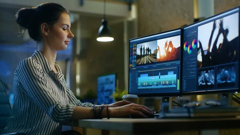 Female Video Editor Works with Footage and Sound on Her Personal Computer. Her Office is Modern and Creative Loft Studio. Shot on RED EPIC-W 8K Helium Cinema Camera.