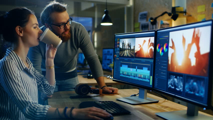Female Video and Sound Editor Works With Her Male Colleague on a Project on Her Personal Computer with Two Displays. They Work in a Creative Loft Office. Shot on RED EPIC-W 8K Helium Cinema Camera. | Shutterstock HD Video #30236191