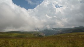 Russia, Republic of Kabardino-Balkaria, time lapse. Summer in the mountains of the Caucasus. Formation and movement of clouds over mountain peaks.