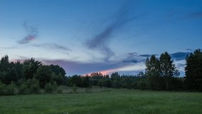 4k time lapse landscape with sunset sky over green meadow. 3840x2160