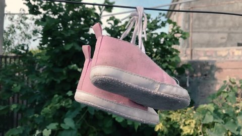 Baby sneakers on the wire