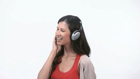 Video of a woman jumping and dancing with headphone