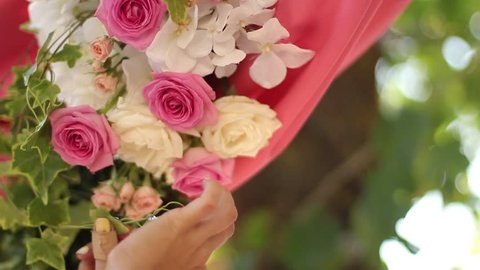 Wedding decor setting sequence clip pack. Florists and decorators making rustic floristic decor with pink roses flower compositions, wood, hay. FullHD 1080p footage