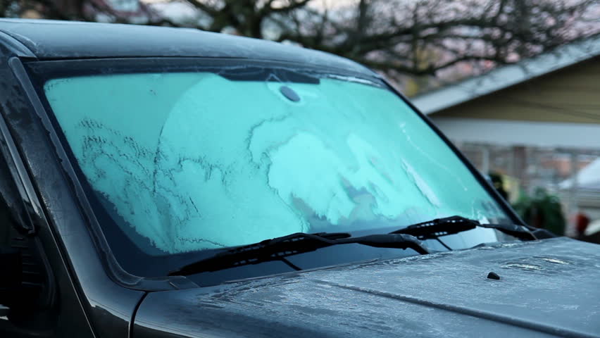 Time lapse of a windshield de-icing on a truck.