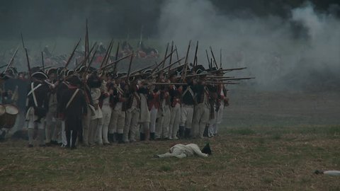 VIRGINIA - OCTOBER 2016 - Reenactment, large-scale, epic American Revolutionary War anniversary recreation - in the midst of battle.  Continental Army Americans fire muskets on British Soldiers. Smoke