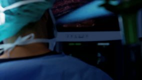 Laparoscopic surgical training operation transmitted on hospital monitor performed by Caucasian male wearing surgical gloves and scrubs RED DRAGON
