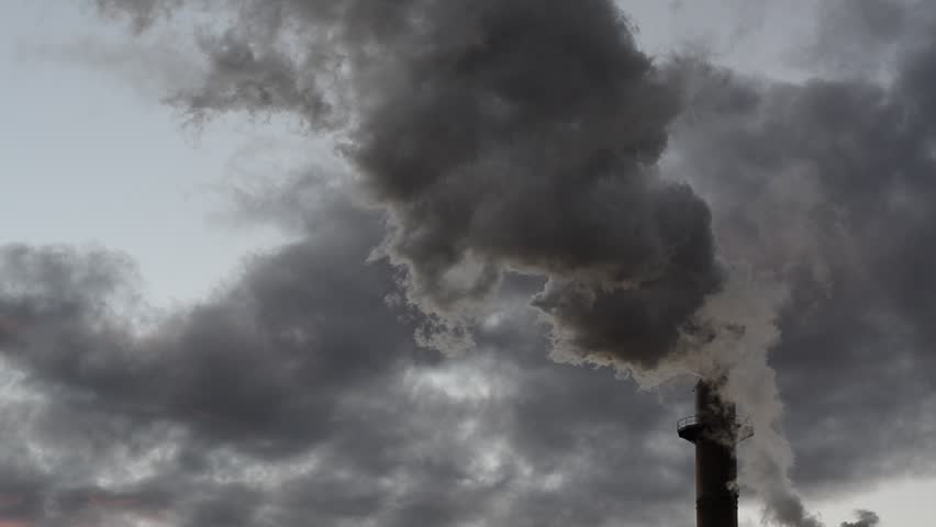 Pollution, smoke and steam discharged from an industrial facility. Time lapse
