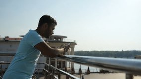 Waist up of positive Indian man leaning on the railing