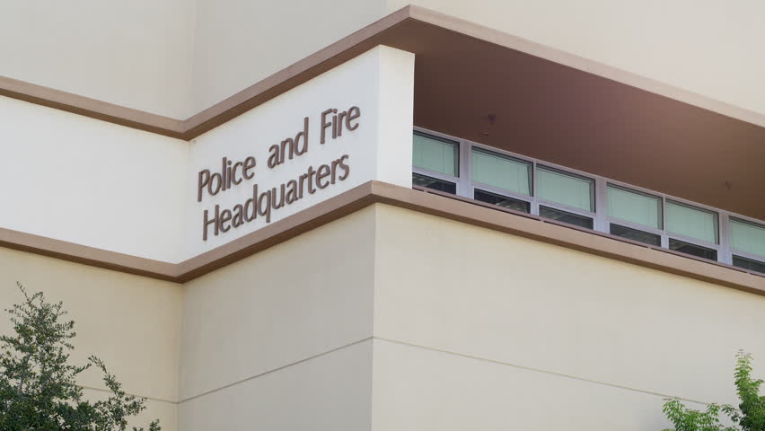 POLICE AND FIRE HEADQUARTERS ESTABLISHING SHOT.  Lock off shot of generic, exterior signage on a building with windows.  Shot in 4K, 10 bit, 4:2:2.