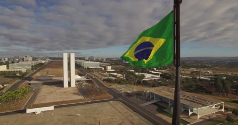 Brasilia aerial - tracking around Brasil flag with Congress in background revealing Supreme Court