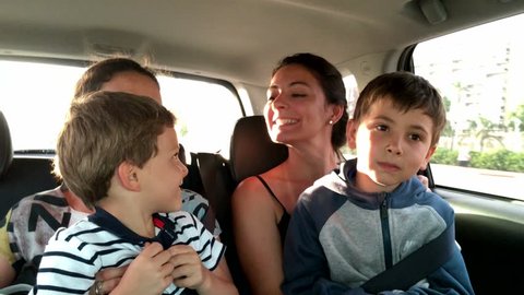Women and children on a trip. Passengers goofing off while on road trip