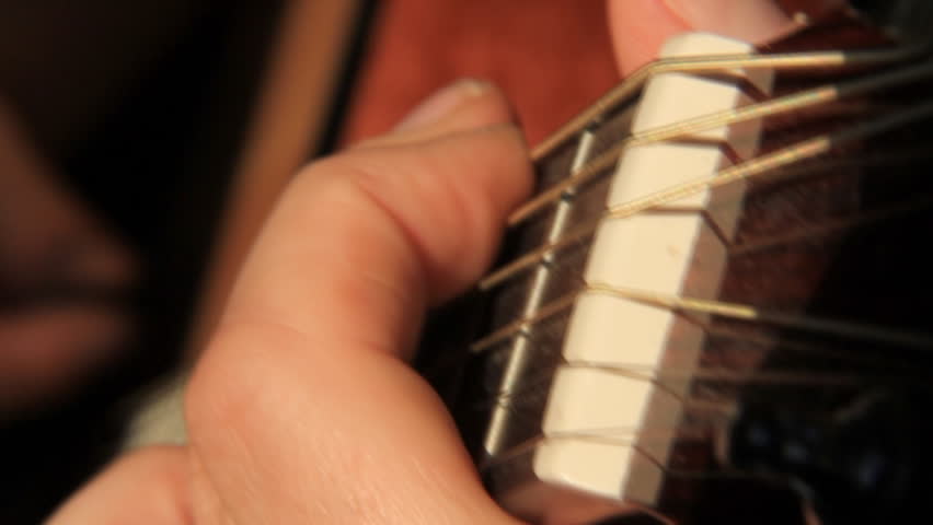 Acoustic Guitar Fingering 1. Close-up shot of a hand forming chords on the neck