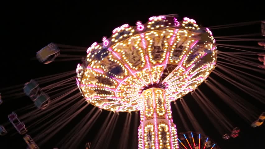 Popular Chair Swing Rides in Amusement Park. Carousel with lights. Night shooting. Looped. Festive fun at the fair Royalty-Free Stock Footage #30286567