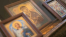 Blurred video. Orthodox icons of the mother of God and guardian angel are on the table. Close up
