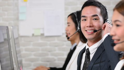 Happy smiling Asian telemarketing customer service agent team, call center job concept