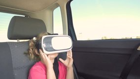 Little Girl a car rides around the city in the helmet of virtual reality. 360 VR Technology.