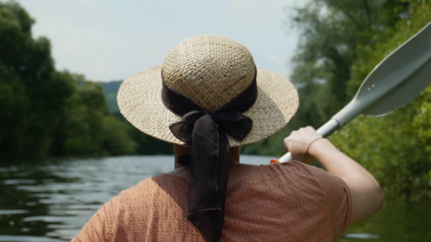 Young girl canoeing in an epic beautiful lake in super slow motion 4k