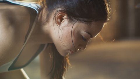 Close-up Shot of a Beautiful Athletic Woman Wipes Sweat from Her Forehead with a Hand, Looks into Camera. She's Tired after Intensive Fitness Exercise. Shot on RED EPIC-W 8K Helium Cinema Camera
