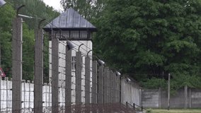 Watch tower at old prison yard with barbwire fence 4k - Powered by Shutterstock - Get 15% off with code: PIKWIZARD15