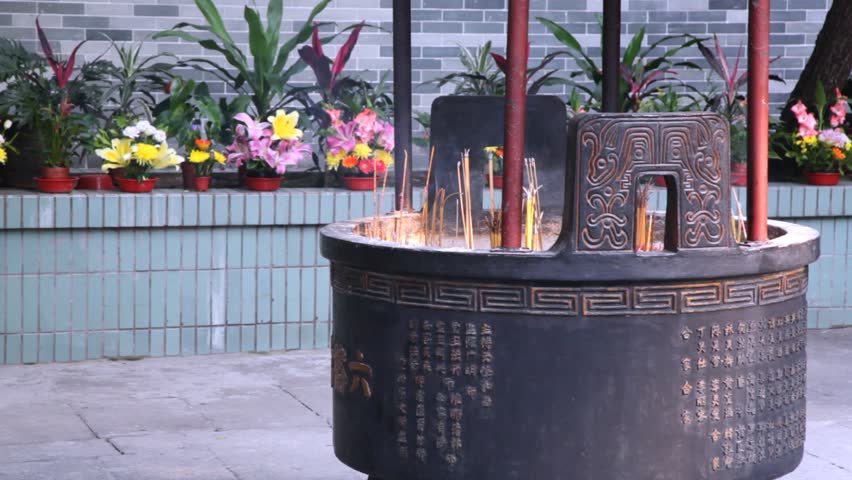 Altar with burning incense in close view in temple daylight