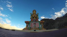 Time lapse of a Monk praying in front of a giant Buddha statue in North India.