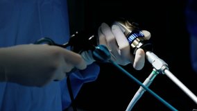 Laparoscopy surgical operation surgeons using Endoscopy and Laparoscope instruments wearing surgical gloves and scrubs RED DRAGON
