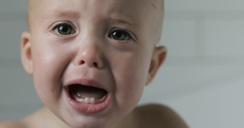 One-year-old baby cries close-up
