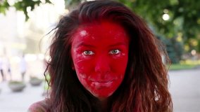 people, 4K and lifestyle concept - Original make up of the young lady at the festival of colors . Slow motion video