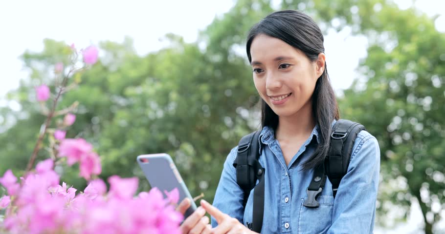 Woman taking photo on the pink flower 