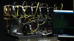 A powerful computer in the process of tools mining bitcoin, which is shown on the monitor